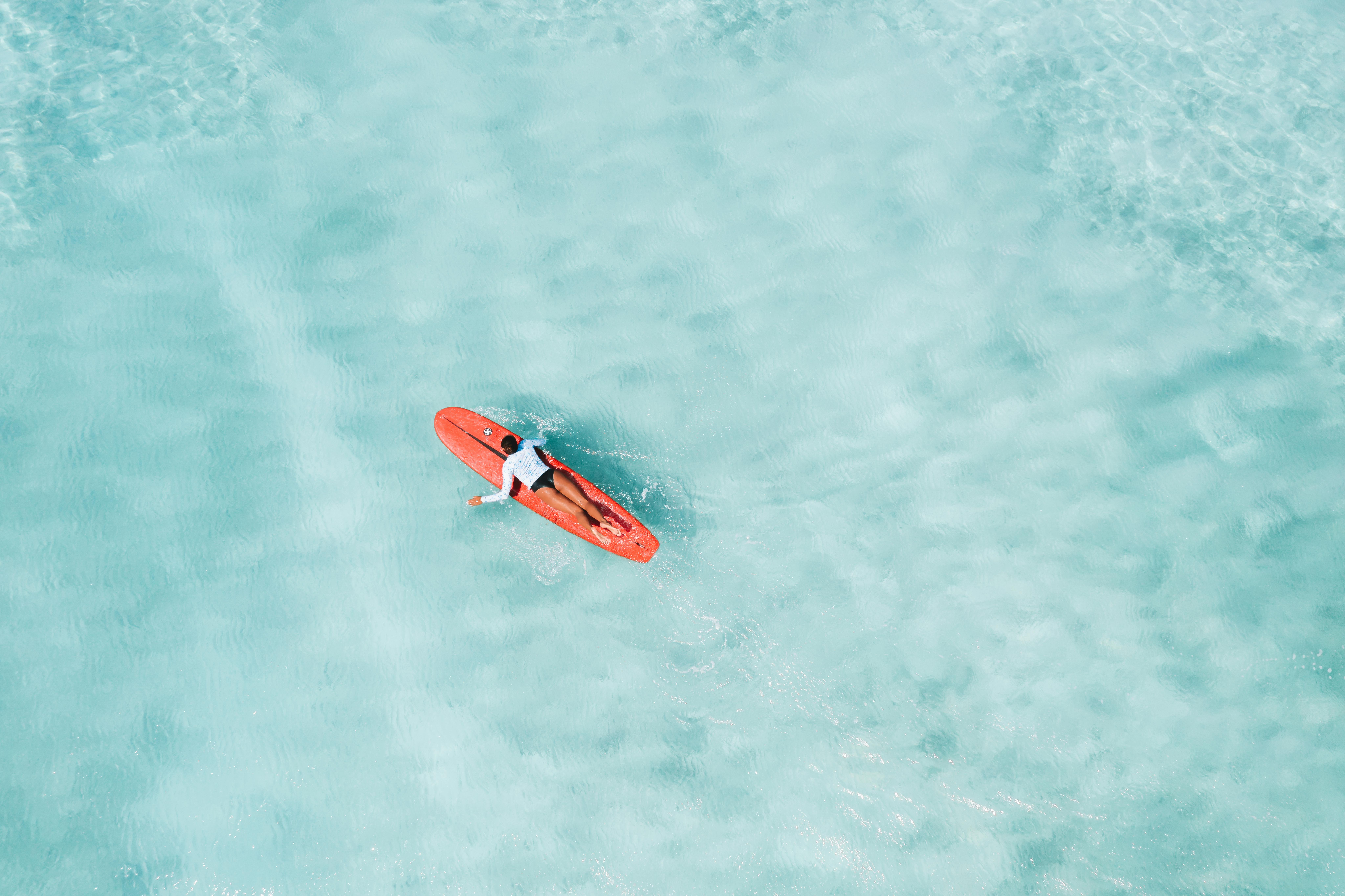 Surfer Lying on Surfboard in Sea · Free Stock Photo