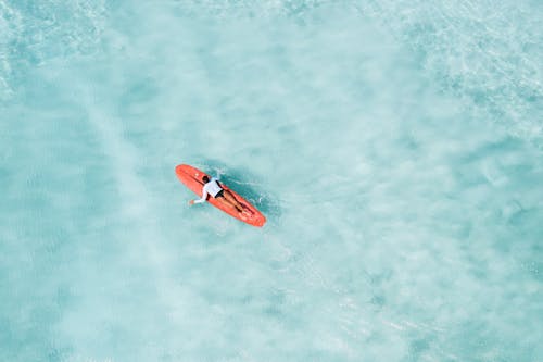 Surfer Lying on Surfboard in Sea