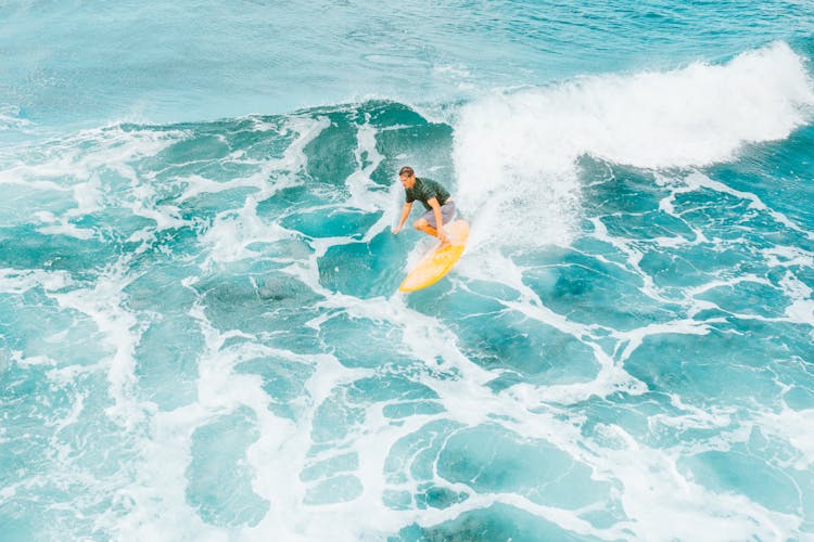 Man Surfing On The Sea