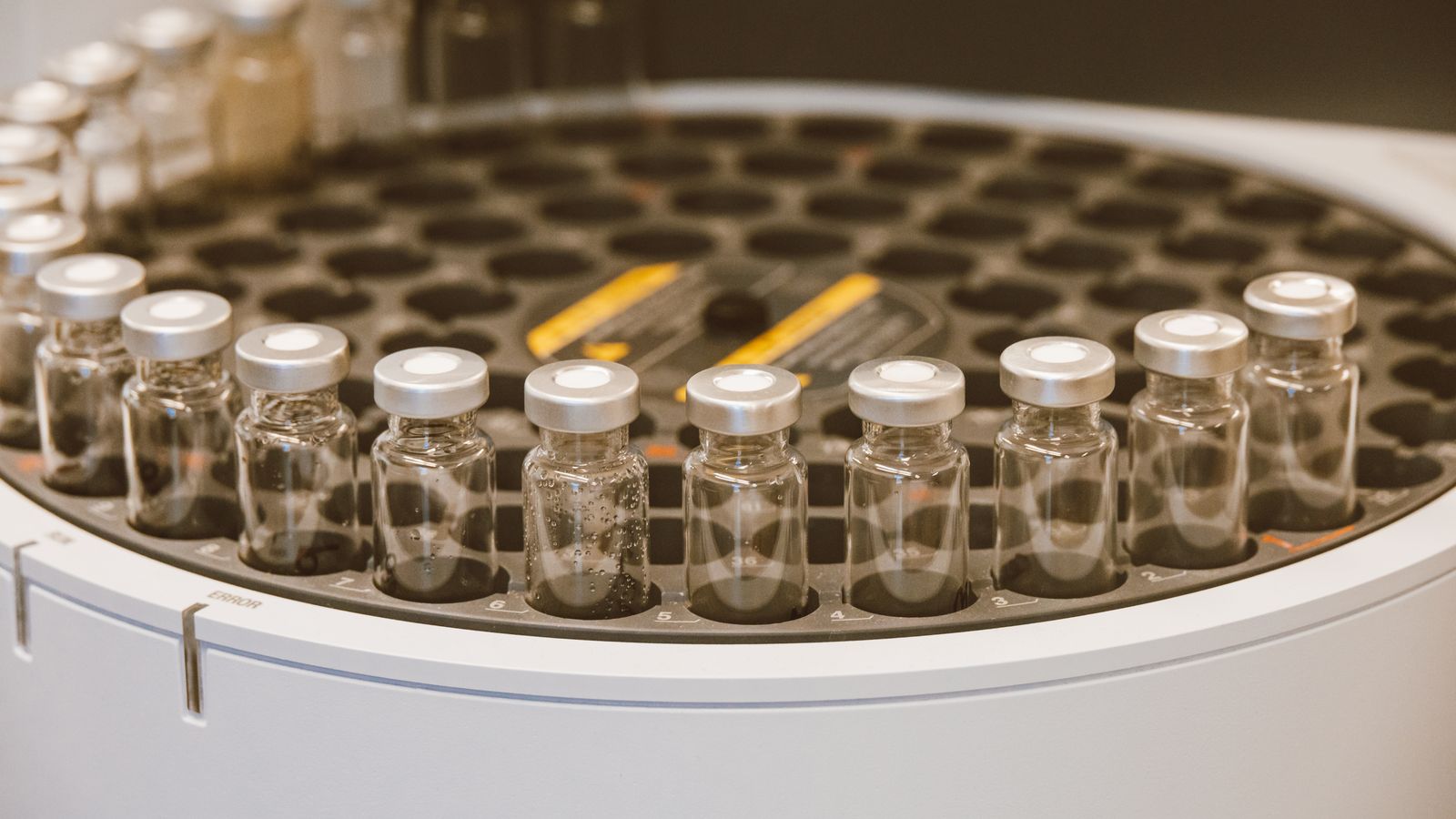 An array of glass vials in a lab setting, ideal for scientific research visuals.