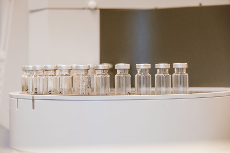 Rows of empty glass vials waiting to be filled — photo by Jess Loiterton on Pexels