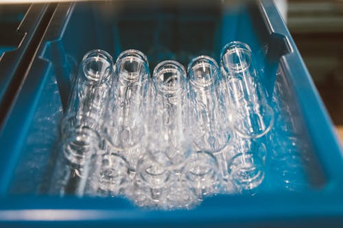 Stack of Glass Test Tubes in a Blue Plastic Container