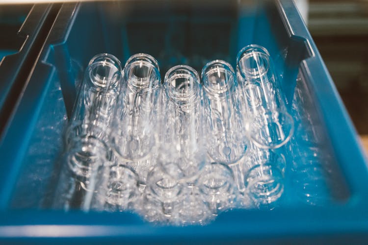 Stack Of Glass Test Tubes In A Blue Plastic Container