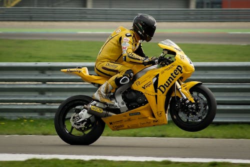 Person Riding on Yellow Sports Bike