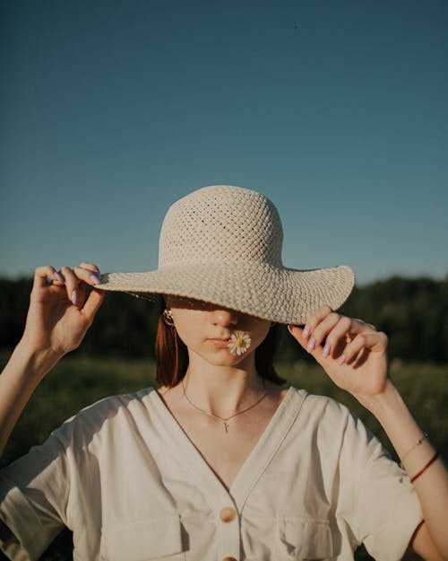 Woman in White Shirt Wearing Brown Sun Hat