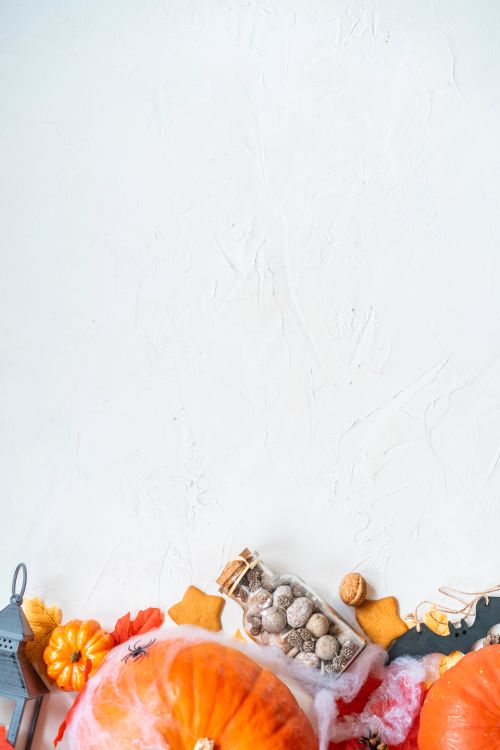Free A Halloween-themed image featuring pumpkins, cookies, and decorations on a white background with ample copy space. Stock Photo