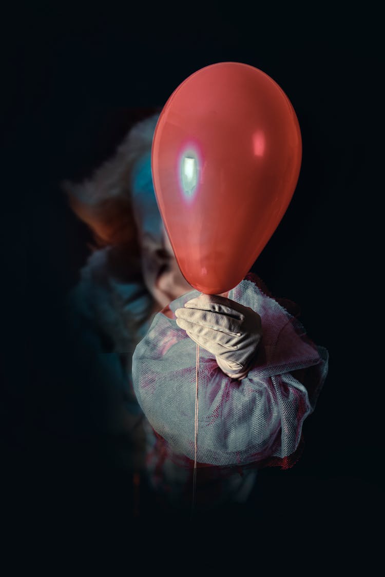 Clown Holding A Red Balloon 