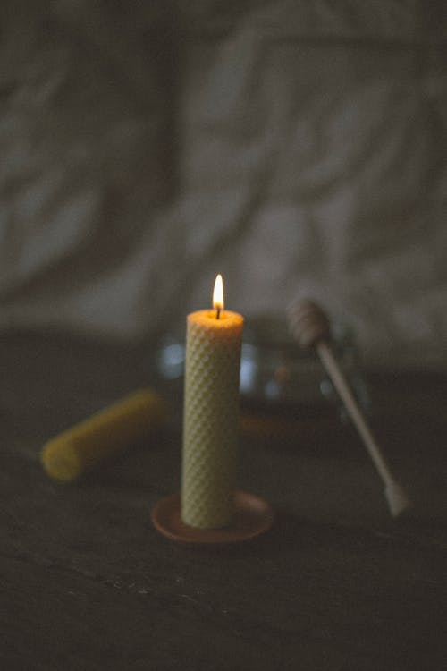 Free Selective Focus Photo of a Lit Beeswax Candle Stock Photo