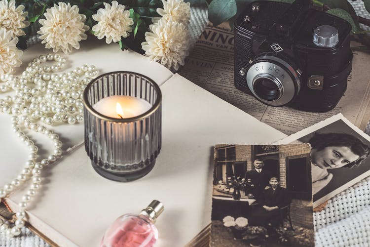 Vintage Analog Camera By Candle And Old Photos 