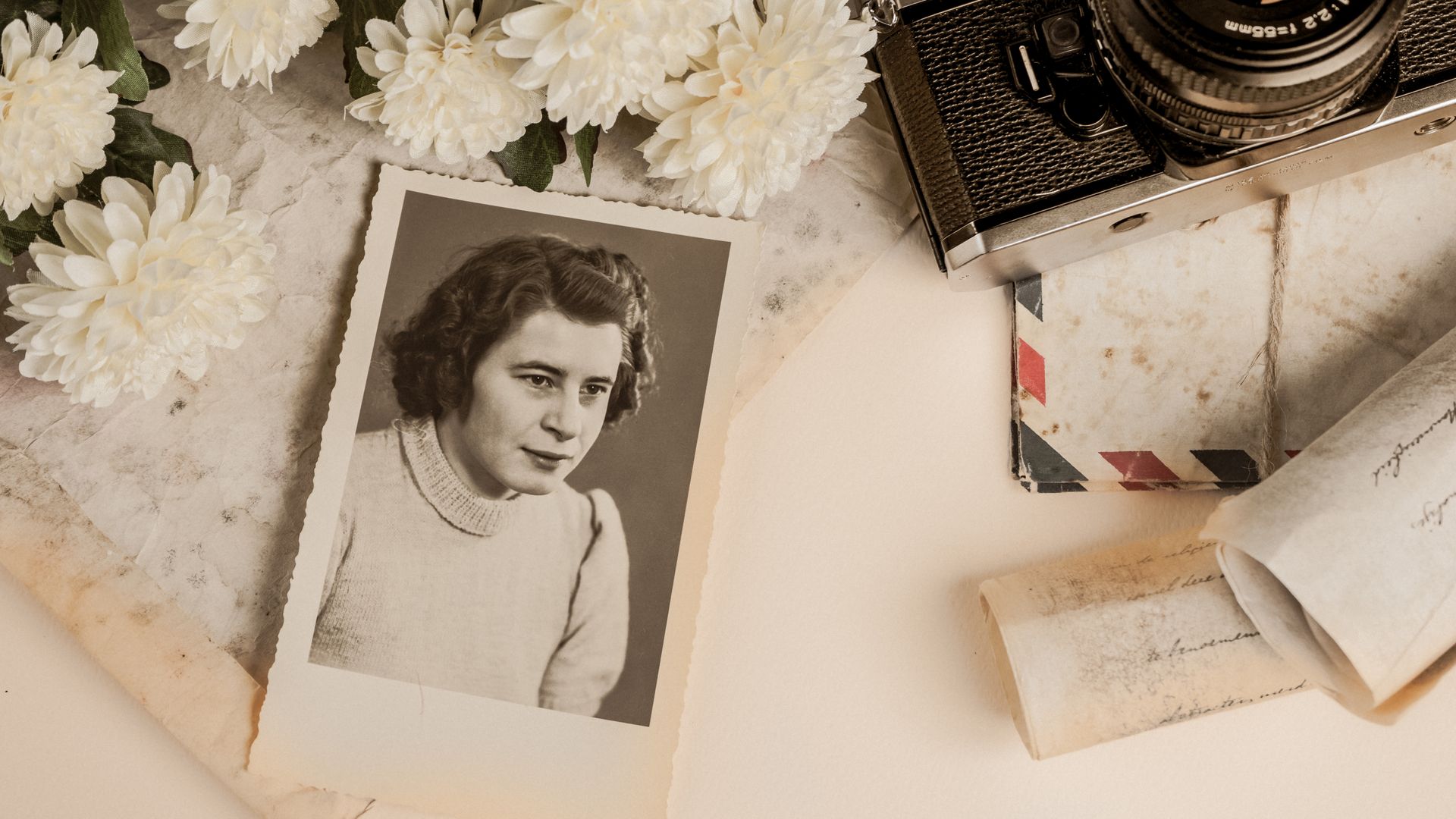 Modafinil's Historical Journey: From Lab to Smart Drug A nostalgic composition featuring a vintage photograph, old camera, and white flowers.
