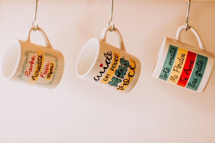 Close-Up Photo Of Hanging Ceramic Mugs