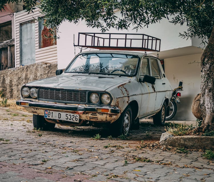 Old And Rusty Dacia 13000 On A Driveway 