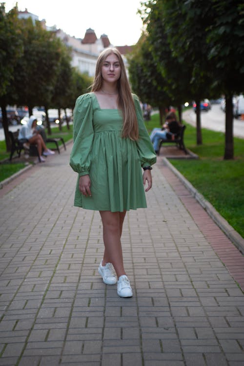 Free Beautiful Woman in a Green Dress Looking at the Camera Stock Photo