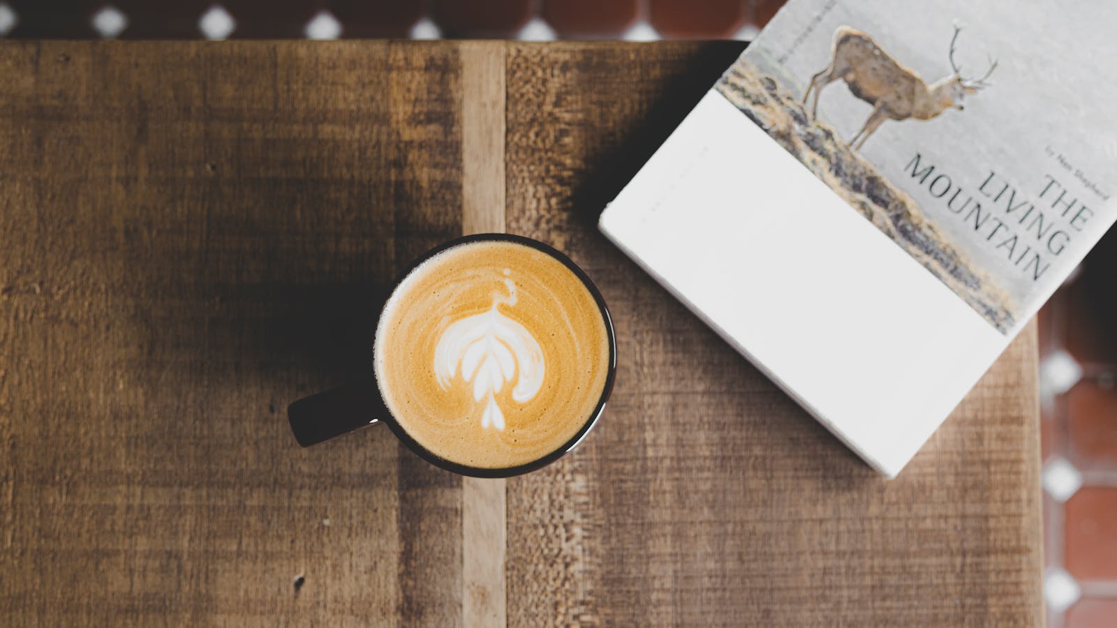 Hot latte in ceramic mug with a thin foam cap