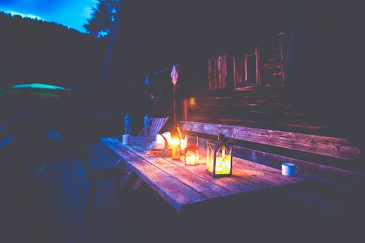 Black Lantern on Brown Wooden Table Under Blue Sky