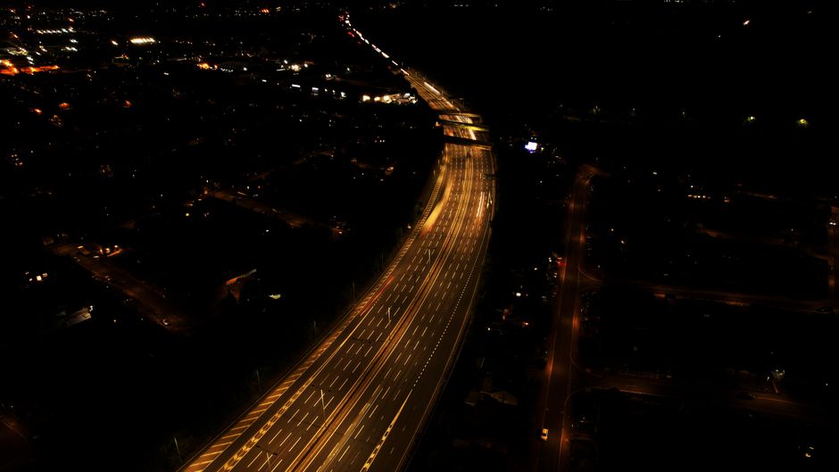 Aerial view of Luton highway illuminated by city lights during nighttime.