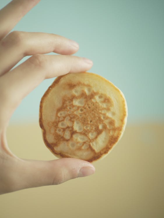 Close-Up Shot of a Person Holding a Pancake