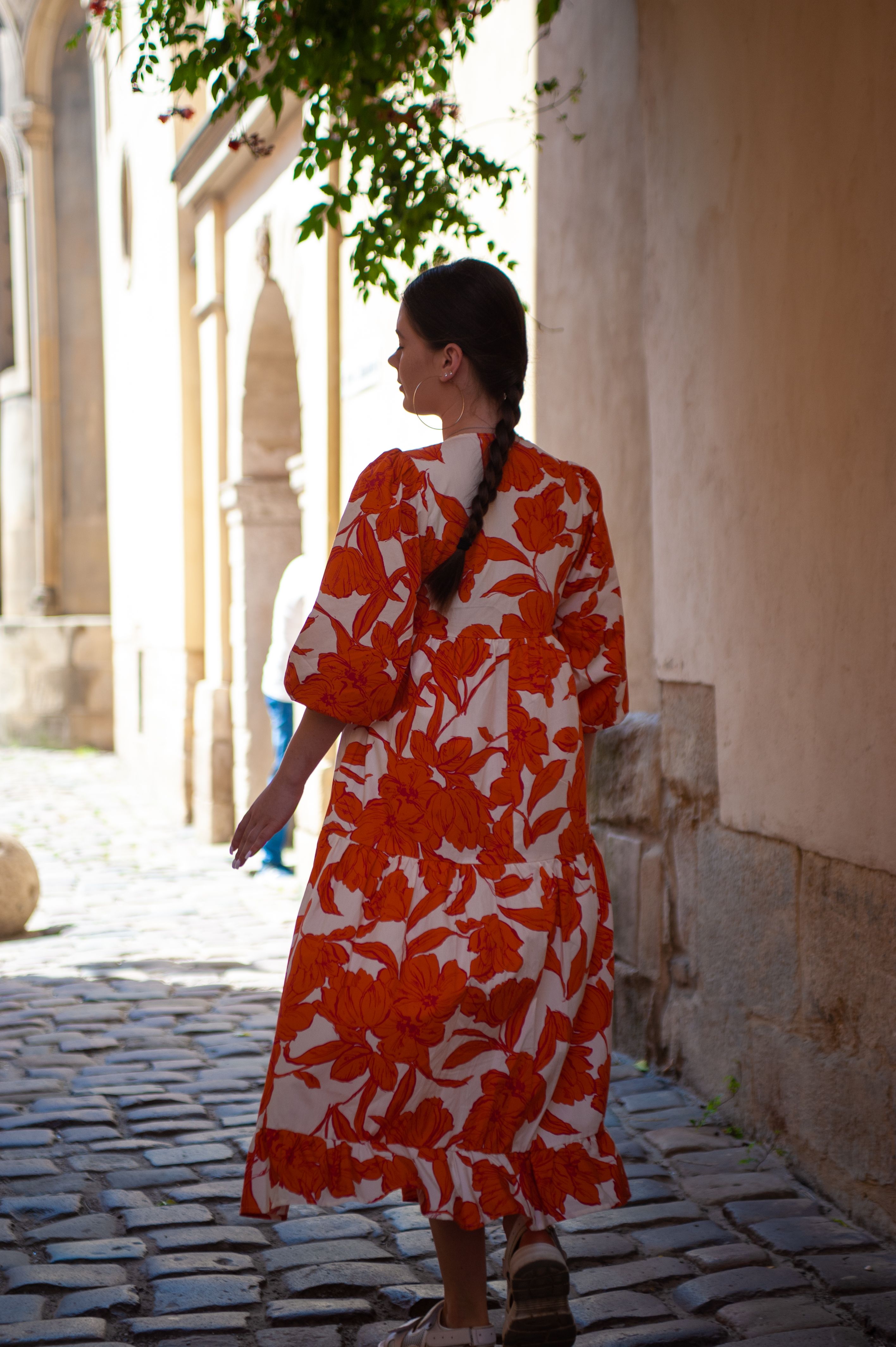 Woman in a summer Dress Walking on a Cobblestone Alley · Free Stock Photo