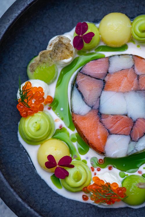Free Elegant gourmet seafood dish with caviar, salmon terrine, and vibrant garnishes. Stock Photo
