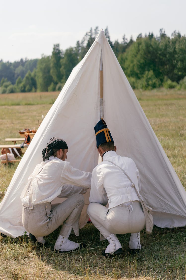 Two Men Fixing A Tent