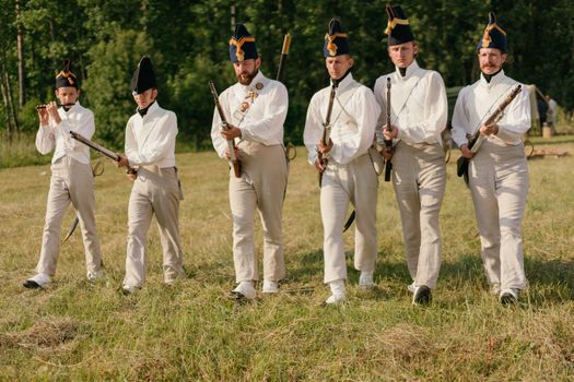 People Holding Rifles