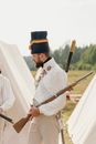 Man in White Artillery Uniform Holding Wooden Vintage Gun