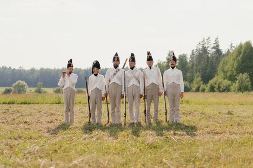 Free Men in vintage military uniforms during a historical reenactment outdoors. Stock Photo