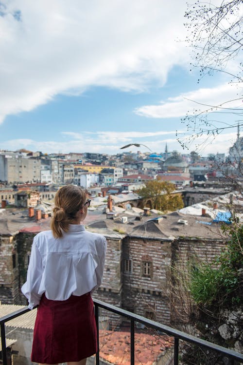 Free Woman on the Balcony Looking at the City Stock Photo