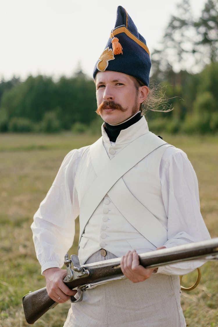 A Soldier In White Uniform Holding A Rifle