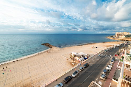 Cars Parked on Parking Lot Near Sea