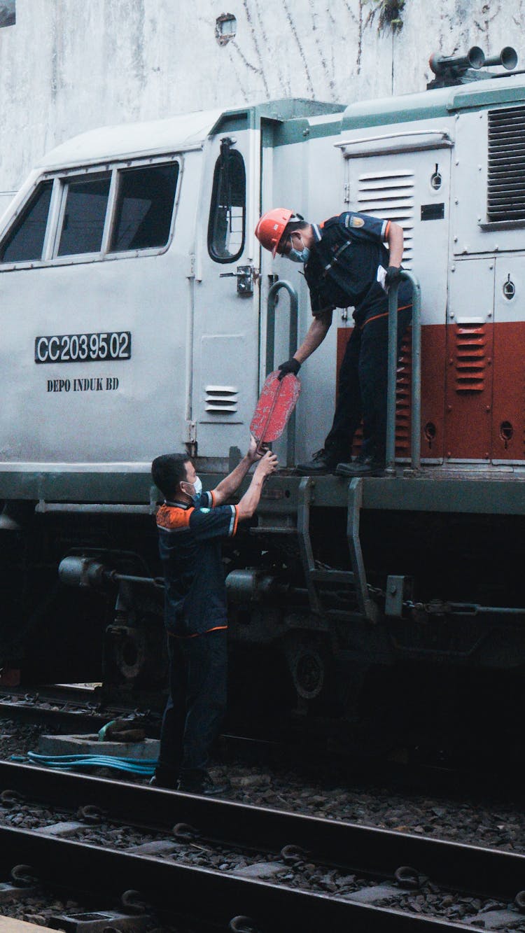 Train Workers Passing An Item