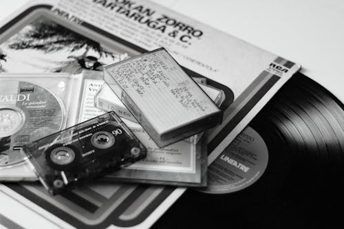 Compact Disc and Cassette Tape on the Table