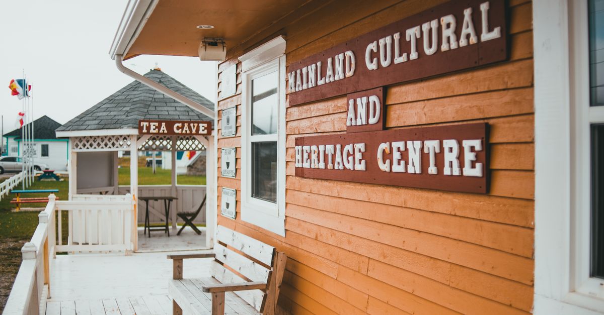 Exterior of Mainland Cultural and Heritage Centre with bench and Tea Cave sign.