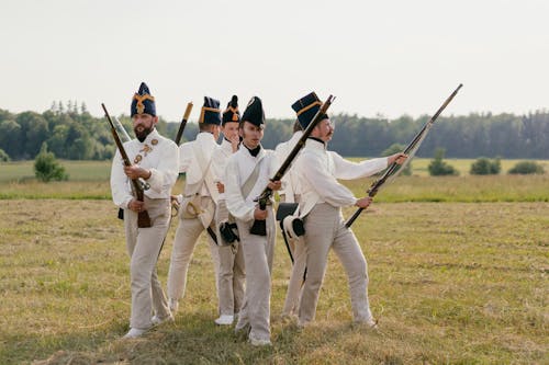 Group of Soldiers in Historical Uniforms Standing and Holding their Rifles 