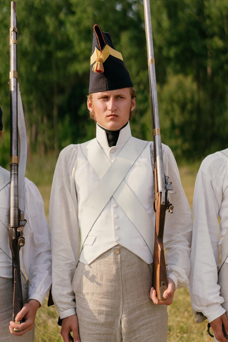 Soldier In Uniform Holding A Rifle