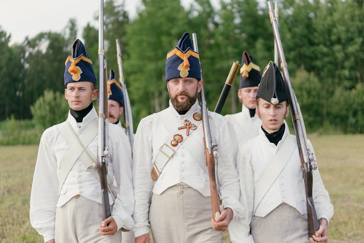 Soldiers Marching While Holding Rifles