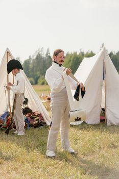 Man Putting on His Military Uniform