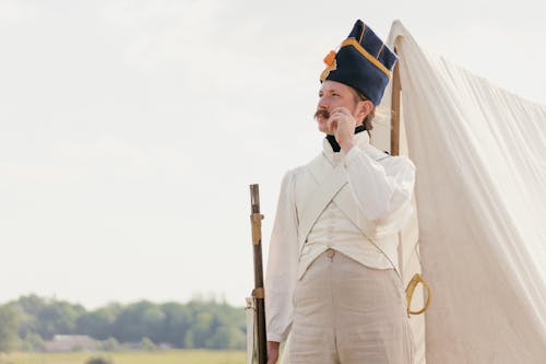 Man in an Officer Costume Standing on a Field during a Historical Reconstruction 