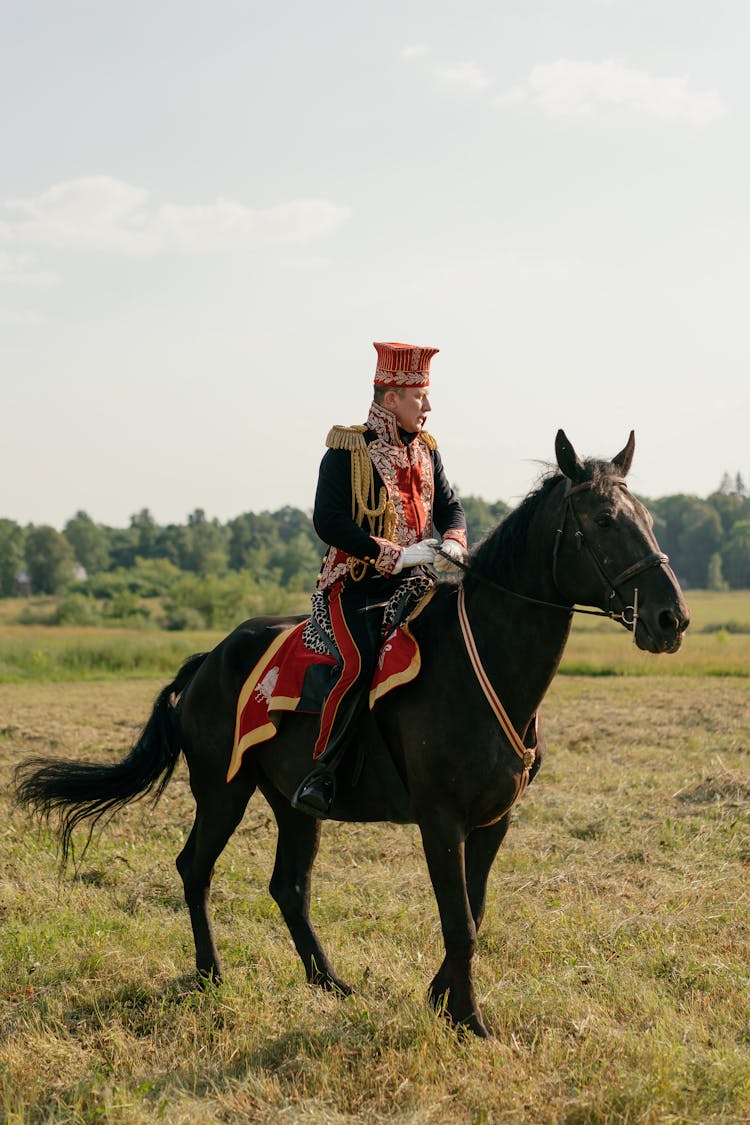 Man Riding A Black Horse