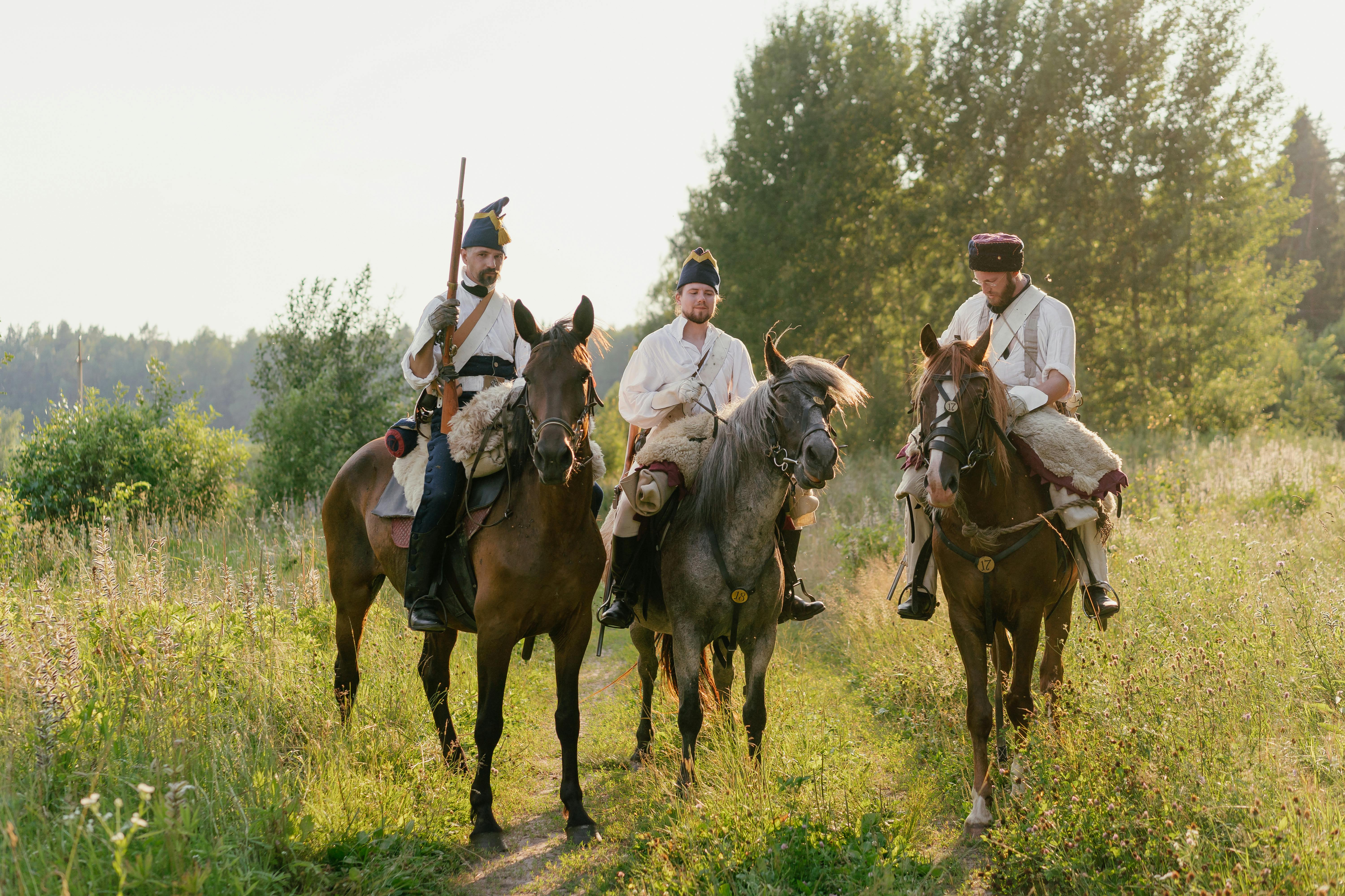 Soldiers in Historical Uniforms Riding Horses on the Country Road