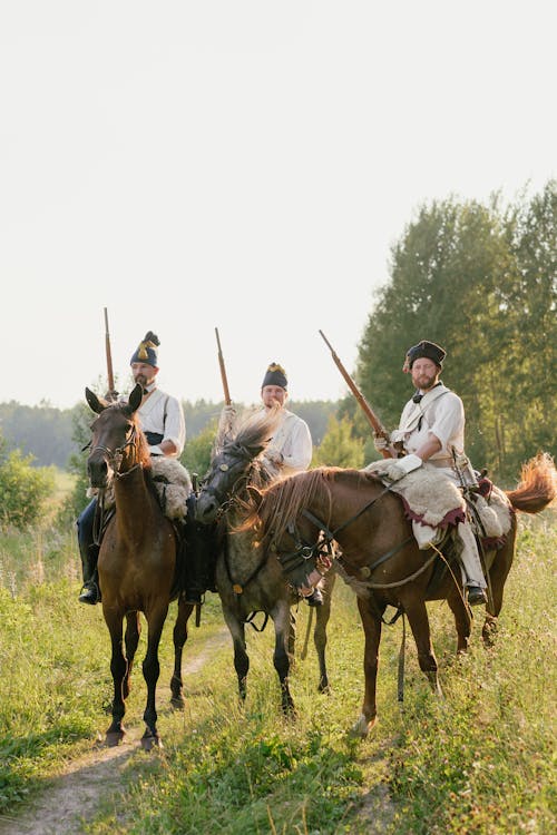 Men Riding Horses Holding Rifles