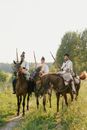 Men Riding Horses Holding Rifles