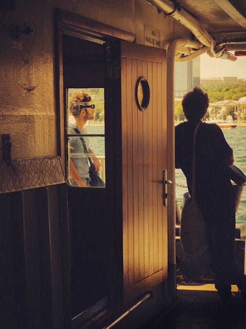 Passengers Looking at a Lake While Travelling on a Cruise Ship