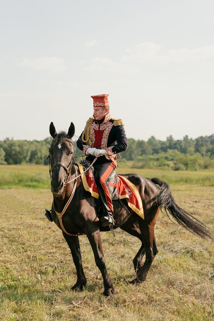 A Man Wearing Uniform Riding A Horse