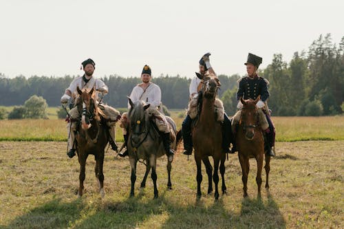 Free Soldiers Riding on Horses on Grass Field Stock Photo