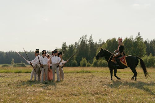 Soldiers in Historical Military Uniforms Exercising in the Grass Field 