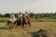 Men on Horses with Guns Recreating Historical Battle