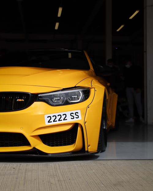 Free A Yellow Coupe Sports Car inside the Garage Stock Photo