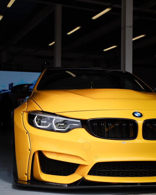A Yellow Coupe Sports Car inside the Garage