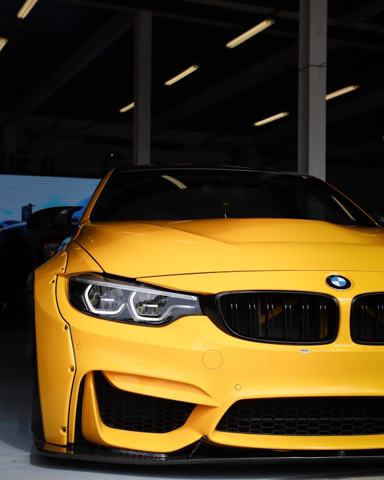 A Yellow Coupe Sports Car Inside The Garage